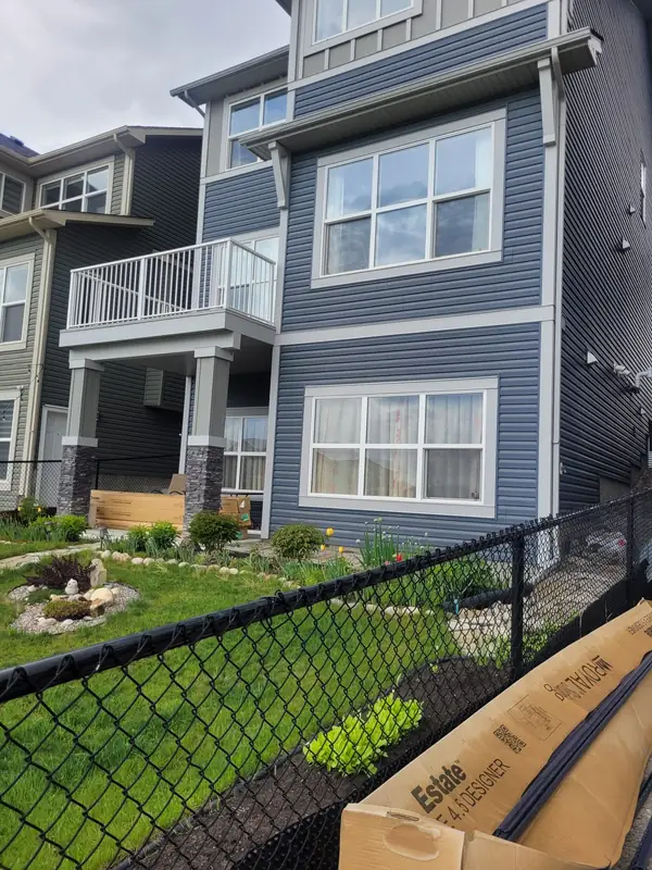 Finished blue siding and white window trim on a Calgary home