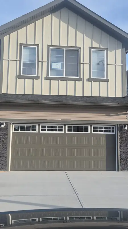 Finished board and batten siding over a new garage door