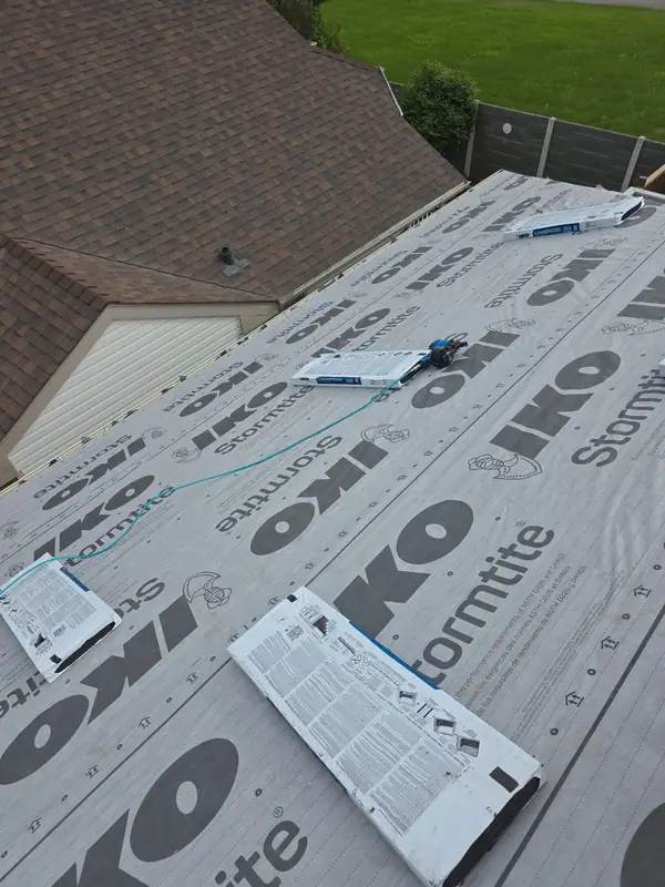 Synthetic underlayment installed across a roof deck