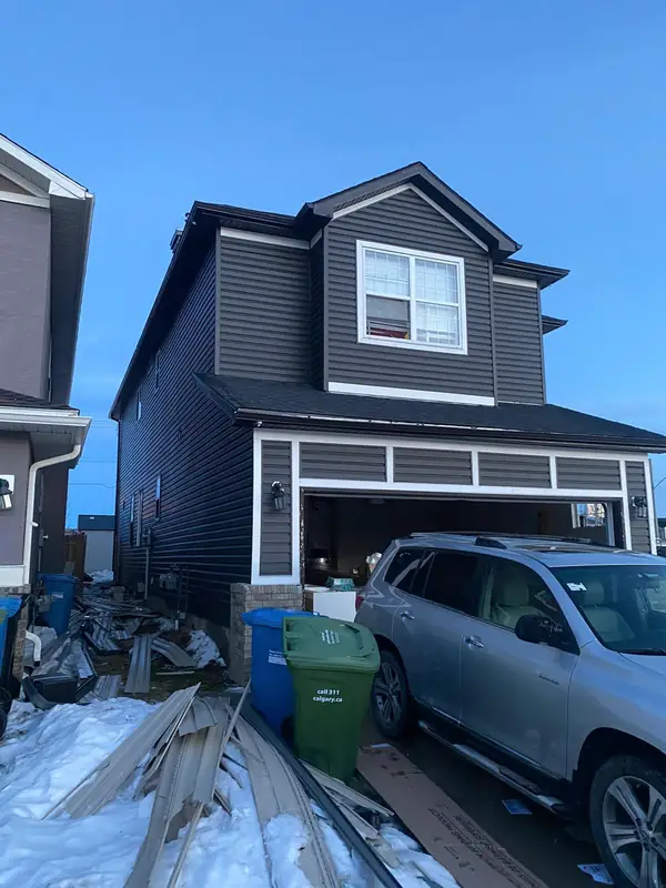 New siding and garage trim during installation